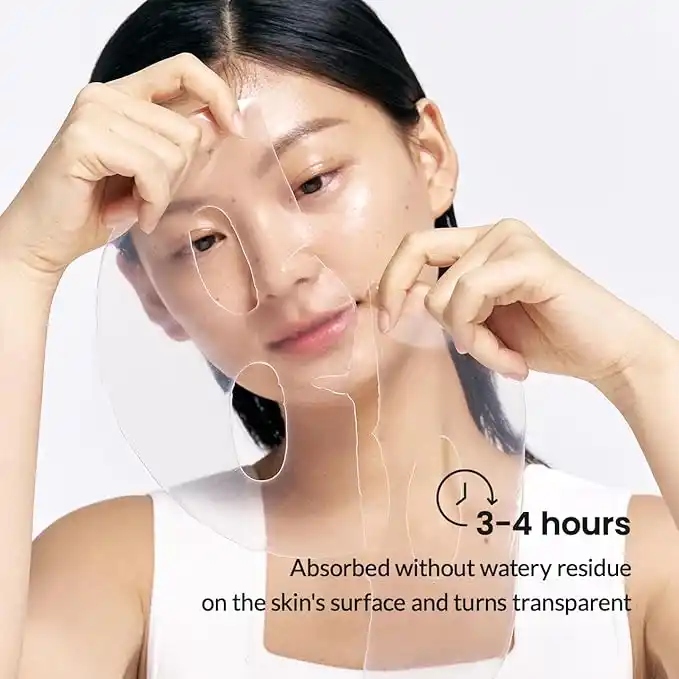 A woman applying a clear, hydrogel face mask to her face. The mask is designed to fit her facial contours and has cutouts for her eyes, nose, and mouth.